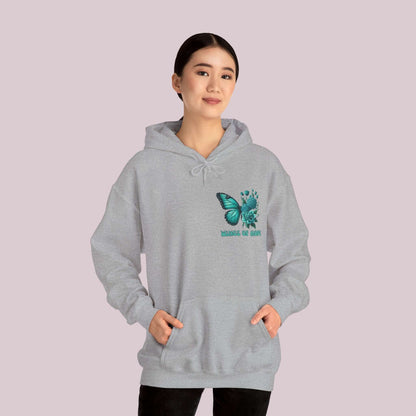 Woman wearing "Wings Of Hope" Butterfly and Flowers Hoodie, featuring a butterfly and flowers design, showcasing comfort and style