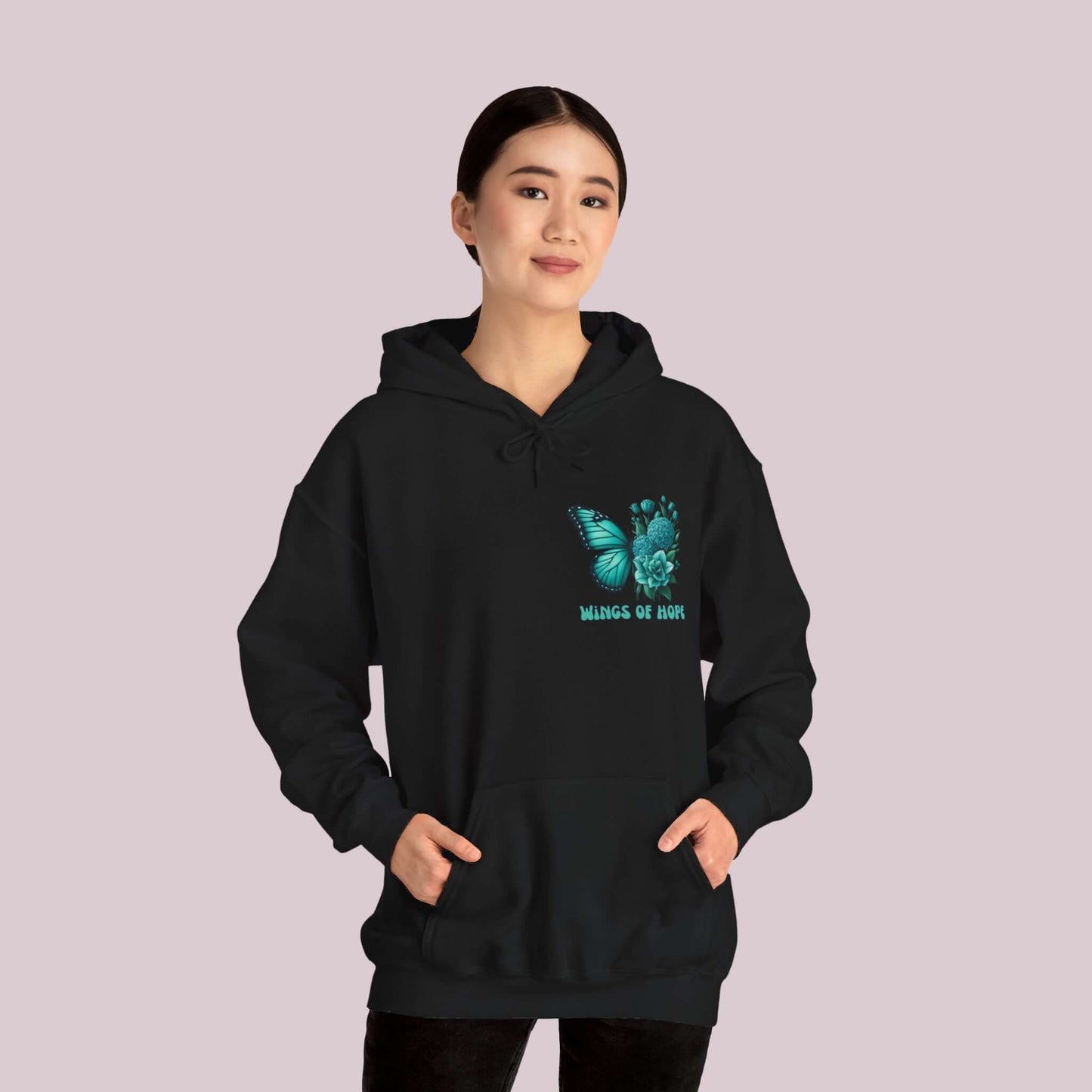 Woman wearing "Wings Of Hope" Butterfly and Flowers Hoodie, featuring a vibrant butterfly and floral design on a soft black fabric.