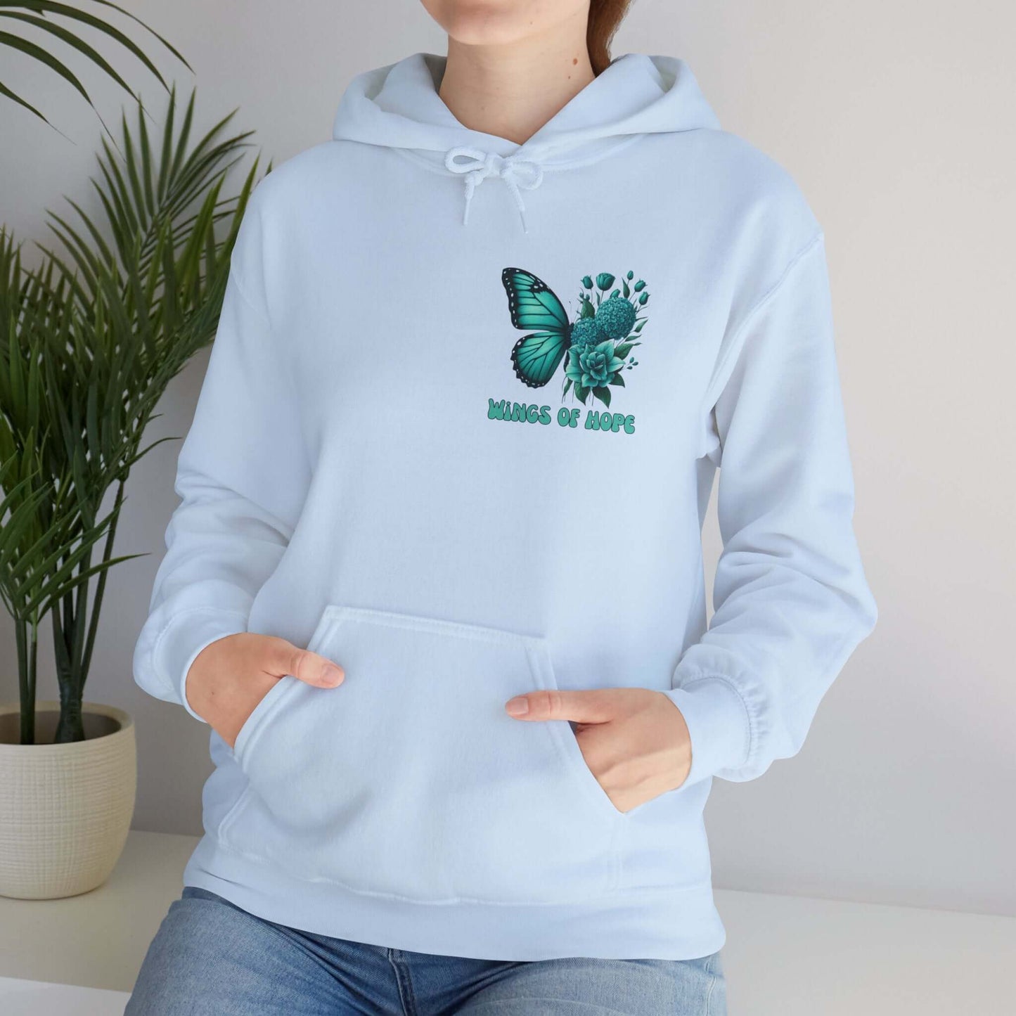 Woman wearing "Wings Of Hope" Butterfly and Flowers Hoodie in white, showing comfort and style with nature-inspired design.