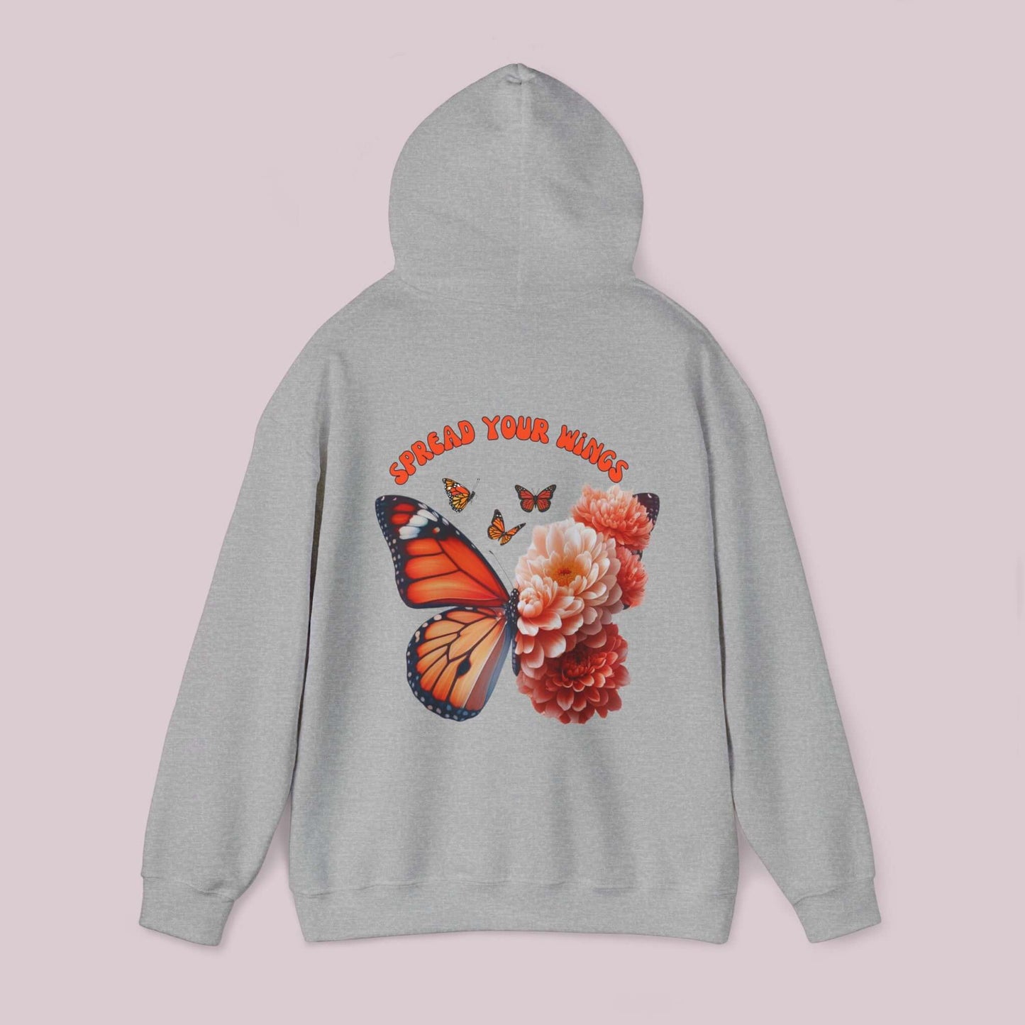 Grey hoodie featuring "Spread Your Wings" text, an orange butterfly, and vibrant flowers design on the back.