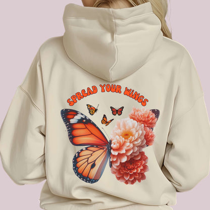 Woman wearing "Spread Your Wings" hoodie with butterfly and flowers design printed on the back